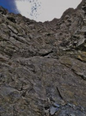 Back at the cliffs I avoided retracing my steps by down climbing a larger, but less un-nerving section. I was totally absorbed picking my way down unprotected; and exhilarated to put the danger behind me upon reaching the bottom. While sliding down the scree towards Esquilant Bivy my thoughts alternated between the prospect of a sit down after a good solid day’s climbing and the satisfaction of having reached two new highpoints. It had been another day in paradise.