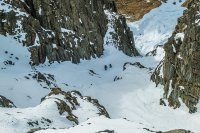 Next morning, after the sun had risen, we crawled out of our bags, stretched chilled bones and got ready to head up the south side of the valley. As we climbed, a couloir revealed itself from behind a rock buttress. It offered very enjoyable cramponing up through a system of exposed shelves. Paul and James had their sights set on a frozen waterfall, with further possibilities looming up above that too. This time, given the extra exposure and fully vertical nature of the frozen waterfall, Kim and Piotr retreated while I tagged along with Paul and James. This image - Looking down the couloir from about 1,400m.
