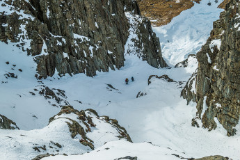 Next morning, after the sun had risen, we crawled out of our bags, stretched chilled bones and got ready to head up the south side of the valley. As we climbed, a couloir revealed itself from behind a rock buttress. It offered very enjoyable cramponing up through a system of exposed shelves. Paul and James had their sights set on a frozen waterfall, with further possibilities looming up above that too. This time, given the extra exposure and fully vertical nature of the frozen waterfall, Kim and Piotr retreated while I tagged along with Paul and James. This image - Looking down the couloir from about 1,400m.