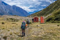 About four hours after leaving camp we trudged in to Ball Hut (1,020m), longing to quench our thirsts. “Looks like the tank’s empty” reported Simon. “What the…” Well, it had been an incredibly hot summer. Upon further investigation he dredged some out after removing the top lid on the tank. “Thank you Simon!”
Beyond the hut was another eight or so kms of gradual descent down the old Ball Hut Road. In places the road has given way to the effects of glacier contraction, requiring short scrambles through scree and boulder fields. Luckily for us our friend Pip was willing to collect us, wherever we met, along the 4WD track above Blue Lake carpark. As soon as Simon got a signal he put in a call and, with still a couple of kms to go to the carpark, her Subaru Forester appeared around a corner. That was nice. Even nicer were the bottles of beer she produced from the boot as we loaded up our gear. I hadn’t realised until then that Pip is an angel.