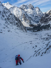 Climbing on Midnight Cowboy, with Mounts Crosscut and Christina behind.