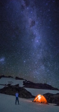 About 3am Mike grunted into action. His bladder finally drove him from the warmth of his bag and I figured I might as well do the same. Just as well, because a quick look skywards was enough to have me diving for my camera and tripod. The Milky Way and countless other galaxies were spray-painted in silver right across the sky. For once looking relatively tiny, Aoraki and her other 3,000 metre plus companions provided a striking silhouette at the base of this spectacle. I climbed, shivering but smiling, back into my bag about 4.30am.