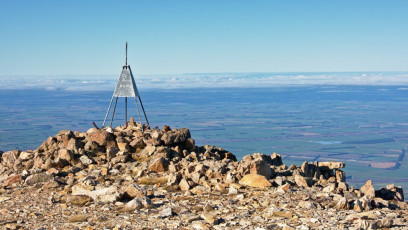 Mount Somers summit trig point and Canterbury Plains. If it wasn't for the light clouds, you could see all the way to the ocean.