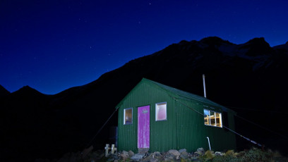 Cameron Hut at night with Southern Cross just above the horizon.  It's a tidy 9-bunker and this night it was packed. It was a long weekend after all. Couple of student climbers, also from Dunedin, slept outside in a tent.