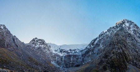 McPherson Cirque. Homer Saddle (1,375m) is the dip on the left, leading right, up Talbot ladder to Mt McPherson (1,931m) - the first snowy pinnacle. On the right is Mt Talbot (2,105m)