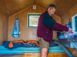 The wind had strengthened considerably, so it was a mighty pleasure to shrug off my pack on the second of the two bunks down at Arete Bivy and fire up a brew. The bivy is a little charmer and in pretty much brand spanking condition, with its own water tank and throne just a little down the tussock bench where it’s situated.