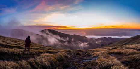Once into the forest it was only another hour or so to Purity Hut (1,320m), which affords panoramic views out to Mount Ruapehu. Our destination for the evening though was Iron Peg at 1,703m, the route to which is very straight forward, lulling me into a false sense of comfort. As we progressed higher though, so the wind intensified.
By several tarns near Iron peg, where we strung up our tent and fly, we battled with fast moving cloud swirling about us. After dinner we sauntered off along the Hikurangi Range to tag Mangaweka, at 1,731m the highest point in the Ruahines. Through breaks in the cloud we enjoyed a blood red sunset.