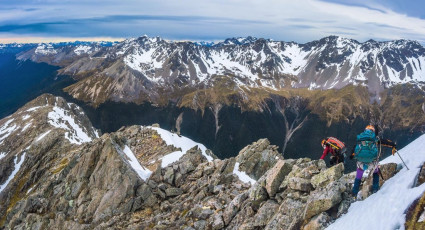 Once that decision was made we discussed a couple of descent options while munching on some calories. While Caro was in favour of a retreat down Summit Creek, in pursuit of less knee effort, I argued for a much shorter route off the eastern side of the ridge. “I reckon that long tongue of flat snow coming off the ridge down there at about 1,950m looks like a friendly ramp. Shall we head for that guys?” 
The section of ridge between us and the “friendly ramp” was mostly broken rock on a moderate gradient, so we felt the tension fall away as we enjoyed the views as we descended.