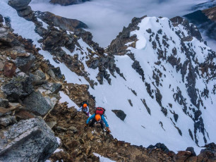 I soon realised that, while the rock made a convincing impersonation of Weetbix, like the snow, it was definitely not to be relied upon for safe handholds or footings. “How far to the ridge” was Caro’s hopeful call below me. “Can’t be far now, but I still can’t see the top yet”. Another stint on snow and then Weetbix later and I still couldn’t see the ridge directly above me. I could, however, see it to my right, just a careful traverse away, so that’s where I headed. This image - Climbing Weetbix at about 2,000m.