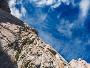 Although it now seemed likely that we’d be benighted if we continued, James was keen to keep going. So he led up a groove that seemed to have plenty of holds. This was the case, but putting in solid protection was another matter. He retreated and tried another line, running the rope up about 30 metres before Piotr and I made the call that there was no way we could reach the top before nightfall. Even then, James’ anchor placement skills were tested to place anything close to a bulletproof abseil point. By the time he re-joined us on the scree it was 4pm. This image - James on our last pitch. This face would have required at least three pitches to regain the ridgeline