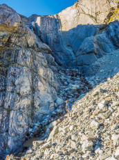 After some discussion and the drawing of straws we elected to go up further to the base of a waterfall to get our supply – easier to carry down than up and the thought of retracing our steps down through all those boulders held zero appeal. In the late afternoon light at least the view from beneath the waterfall, back down Cloudy Stream across to the Two Thumb Range, was worth the effort.  This image - at our water source up valley.