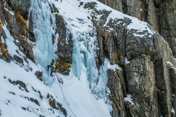 Up beside James, while the blood painfully gushed back into my numbed hands, Paul also followed up. I felt a little better about my own performance when I heard Paul grunting in pain after also clearing the lip. Because I wasn’t able to clean the route of the ice screws on my way up he had had to, therefore spending longer on the face than me. His hands were also numbed and now giving him grief as the blood returned. 
Although a short pitch, James and Paul judged it to be grade 4 ice terrain due to the verticality and hardness of the ice – a superb learning experience for me and enough to tell me that I won’t be leading any grade 4 ice pitches anytime soon. There was more climbing to be had directly above us, but both Paul and I were satisfied to back off. I got a fine lesson in V thread placement, then we rapped back down our pitch.
This image - James abseiling down the pitch he led.