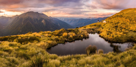 To secure a water supply for our bivvy site up on Biggs Tops, we had to abandon the poled route leading on to Trevor Carter Hut, branching right/east to a lovely tarn nestled in a small basin, arriving about 5pm after about seven hours of hiking. If anything, this spot was even more impressive than our first bivvy back on the Arthur Range. This image - A dusk view across the tarn to our campsite and Mt Kendall.