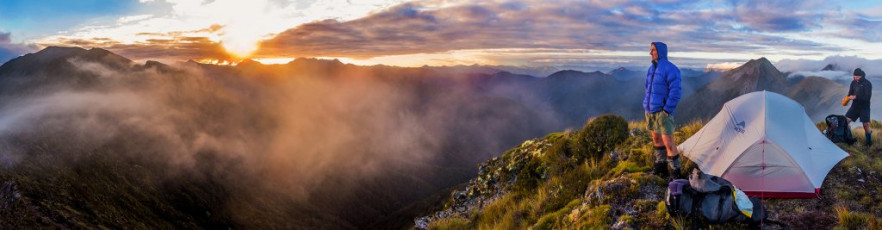 An initially favourable but deteriorating weather forecast prompted our first evolution to the plan. Shaun figured that, by reversing our route, we could get up onto the tops rapidly to enjoy the first four days of mild weather. By the afternoon of day four rain was expected and, beyond that, well who knows in this climate changing world. With packs over 20kgs, the initial climb up to John Reid Hut and then on to the southern end of the Arthur Range seemed pretty brutal. No pain no gain though and we certainly made a gain. For photographers, our bivvy spot at 1,463m that night, then the one two nights later on Biggs Tops, were visits to heaven. This image - A dusk view from our 1,463m campsite on the Arthur Range, spanning the Luna Ridge and Mt Baldy (far right).