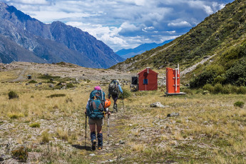 About four hours after leaving camp we trudged in to Ball Hut (1,020m), longing to quench our thirsts. “Looks like the tank’s empty” reported Simon. “What the…” Well, it had been an incredibly hot summer. Upon further investigation he dredged some out after removing the top lid on the tank. “Thank you Simon!”     
Beyond the hut was another eight or so kms of gradual descent down the old Ball Hut Road. In places the road has given way to the effects of glacier contraction, requiring short scrambles through scree and boulder fields. Luckily for us our friend Pip was willing to collect us, wherever we met, along the 4WD track above Blue Lake carpark. As soon as Simon got a signal he put in a call and, with still a couple of kms to go to the carpark, her Subaru Forester appeared around a corner. That was nice. Even nicer were the bottles of beer she produced from the boot as we loaded up our gear. I hadn’t realised until then that Pip is an angel.