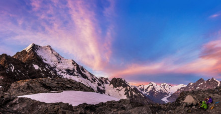 By the time we reached our campsite, across a snow field skirting Ball Glacier, about 70 metres below the Pass, it had been about an eight hour day. As far as memorable campsites go, this one was right up there. Two nice flat areas have been carved out and protected by low stone walls, in a sheltered spot commanding unbeatable sunrise/sunset views. Though it took us a while to spot them, there were two tiny tarns – more rock pools actually, right under our noses, nestled in a small outcrop beside the campsite. We settled in to enjoy all this, hoping that the less than appealing weather forecast would not bear out. It didn’t and my camera got a thrashing. This image - A dusk view from camp of the Caroline face of Aoraki Mt Cook left, stretching away to the Tasman Saddle.