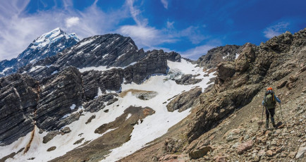 To gain the Pass required a sometimes exposed rocky traverse around beneath Mount Rosa to a snow field, which we joined at about 1,800m. This went up in a north easterly direction to the Pass, though the last 30 or so metres were on steep slippery gravel. This image - At about 1,700m, pondering the upper section of the western side Ball Pass route. The Pass is in the obvious dip in the ridge above the snow.