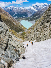 Up we went - initially steep scree, then 300 or so vertical metres of steep snow. By now the sun had caught up with us and, as we cramponed up, sweat poured off. The chute narrowed to a choke stone that I imagined could be a challenge in winter conditions, especially if descending.