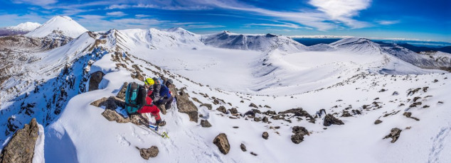 Perfectly located to enjoy lunch, we took in virtually our entire route, with spectacular close views of some intimidating vertical cliffs, Central Crater directly below and Red Crater just to the south. In warm sunshine and not a breath of wind, our enjoyment was further enhanced, as we watched a straggly line of guided ants plodding along the main route below. Both complete mountaineering novices, Juan and Raoul realised then just what a special kiwi outdoor experience they were enjoying, telling me it was the most impressive of their international backpacker travels so far. This image - On the 1,850m high point beyond the southern end of Blue Lake looking southwest to, from left,  Ruapehu, Ngauruhoe, Red Crater, Tongariro, North Crater Plateau and Rotopaunga. Central Crater and Blue Lake are in the foreground.