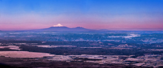 For me, the other motivation for this trip was to tread new ground on that most famous of places, Tongariro National Park. The estimate for 2016/17 was 130,000 walkers on the Tongariro Crossing – an average of 356 for every day of the year, although apparently the peak in summer reaches 2,000. In a single day! But I knew it’s still not difficult to dodge the crowds. Visiting in winter cuts the numbers down dramatically, although even then we encountered several guided groups when our route intersected the trampled trail of the main crossing. But, in good conditions, there are almost unlimited options on this relatively easy terrain to avoid the madding crowd. This image - Mount Taranaki at dawn, from North Crater's southern rim.