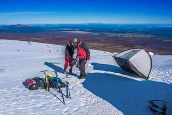 Later, back down near camp in the midst of a number two nature call a mischievous breeze suddenly blew down from the north, snatching my toilet paper roll from my hand. In my compromised squat I watched in dismay as it bounced and unrolled off down the slope. Luckily I still had the unrolled end in my grasp and, to my surprise, the eight or so metre strand didn’t snap. Like a rope I coiled it back in, stuffed most of it into my coat and completed my delicate task. Not long after, just as we’d set the main tent igloo free from its fly that breeze snuck through again and nearly carried the tent in the same direction as my toilet roll. Quick reactions just saved the day. This image - Relieved of its fly, our tent tries to make its escape in the morning breeze.
