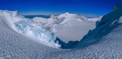 Kathy and I waited in the calm of the saddle, expecting to see three other figures emerge on top any moment. As time dragged those other two climbers didn’t reappear either. I anguished about whether we should push on without them or not. We hadn’t actually discussed what our now split party would do beyond the summit. This image - A view from the icy saddle between Te HeuHeu and Tukino, across the plateau to Tahurangi (2,797m).