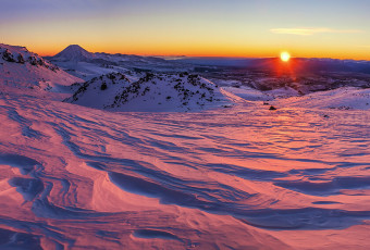 The first section up through Tukino Ski field was very straightforward – good terrain to generate some body heat for warmth. As we reached a ridge at about 2,000m on the north side, a molten orb breached the eastern skyline, treating us to some alpenglow on steroids. Otherworldly scalloped snow caught the low angled rays, creating a luxuriant scene at our feet that just stretched away to the horizon around us. Our route lay ahead, bathed in mauve. This image - A view from about 1,900m, north east to Ngauruhoe.