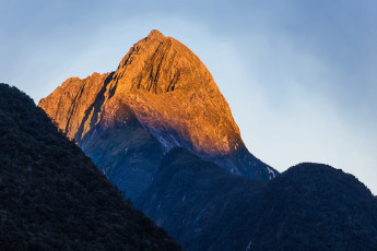 I’d been keen to climb Mitre Peak (1,683m) for some time. Though under 1,700m, the climb begins at sea level, so it’s still a significant undertaking. And the peak is just such an icon. A real postcard celebrity, photographed by nearly every international tourist who visits our South Island. The previous summer another Alpine Club friend, Mike Neely and I had come south to have a crack, but the weather was poor in Fiordland so we went up to the Annette Plateau in Aoraki National Park instead.  
This time I was with two other Alpine Club friends, Simon Williamson and partner Carolyn Ellis and our luck with the weather seemed to be with us. We’d just enjoyed two magnificent days doing the Ball Pass route, followed by a rainy travel day down to Homer Hut. Now the weather had cleared again – windy on day one but calming on day two, before another front was forecast that evening – it was on.