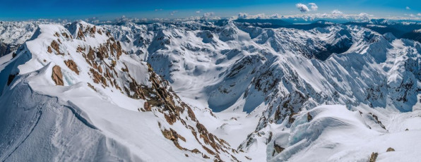 James put in three not totally bullet-proof cams but, as the final section below the summit came into view from behind the rocky outcrop where he stood, we could see that a fall was going to be unlikely. The rope still had a calming influence though as I climbed through and set up a T slot just below the summit for James to follow up on.
This image - Looking north and west from the summit, with the rest of Mt Rolleston extending left above Crow Glacier. Mt Armstrong (2,110m) is in the middle distance and Mt Philistine and Rolleston Glacier far right.