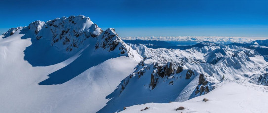 The route on to the summit dropped off low Peak to the upper edge of Crow Glacier, skirting beneath a steep rocky buttress, before climbing again into another notch.