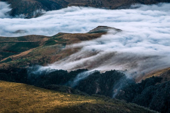 Sunken cloud contouring the landscape in the valley below