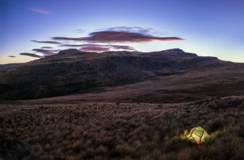 For two photographers, dawn was a particular treat before we resumed our now gradual climb, up through tussock slopes and rocky outcrops, to the summit. This image - Our campsite, with the summit area of Mt Somers above