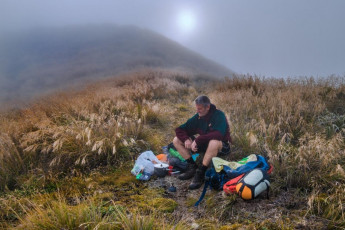 Since departing the Holdsworth carpark it took me ten hours to reach my bivvy spot just a tad east of Aokaparangi’s summit that evening. Most of the way had been in bush and it was humid. I had sweated profusely and constantly most of the time and some very unwanted chaffing, in various unpleasant spots, had become increasingly apparent. At least it was good to be free of the closeness of the bush for a while. On top though, I was engulfed in cloud and, with no tarns in sight, I had to use my water sparingly, knowing that Maungahuka Hut was still two or three hours walk away to the south. But with a good forecast, the main point of my trip was to be on the tops for dawn