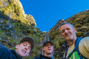 By the time I and my arthritic knees reached the top of the ladder in the exposed and craggy little notch between Tuiti and Tunui, the 1,325m twins known as the Tararua Peaks, Ed and Will were already lounging nonchalantly at the bottom. Damn it, I wanted to get some shots with someone on the solidly constructed aluminium structure. “Ed, climb up a bit so I can shoot you.” To do that I had to gingerly dismount the ladder onto steep tussock on the side of the ladder, then hook an arm around the top rung before going to that somewhat more precarious through-the-lens space. This image - at the bottom of the ladder