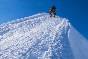 From tent to summit took four hours. The descent added another two and, after a brew, food and packup, our drop down to Brewster Hut through very soft, knee and thigh deep snow took two more. This image - Piotr climbing above the point we joined the summit ridge from the southwest face