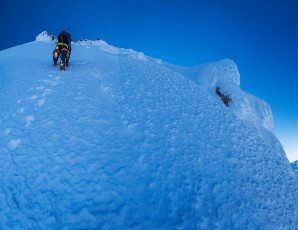 From there our route essentially went straight up, all the way to the summit ridge. On the face, the snow was softer than on our approach, making for good step plugging as we free climbed. Even so, as we progressed higher, the yawning exposure at my back kept me fully focused on maintaining three points of contact.