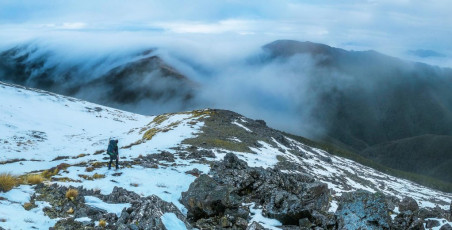 Next morning we set off again with hopes of clearer weather that would allow us to put in a fairly long day, over Mount Rintoul and down to Rintoul Hut. But we had another short-circuit option in Old Man Hut, should the weather remain clagged.
This image - Ridge top travel between Slaty Peak and Old Man.