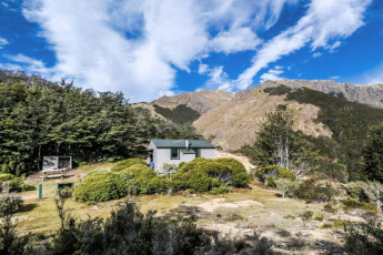 From there our climbing began. Another couple of hours saw us drenched in sweat, about 1,000m higher up, at Starveall Hut. The tree line in the Richmond Range is above 1,400m - higher than most other places in New Zealand. Starveall Hut is just under 1,200m, but it sits in a dip clear of trees, offering nice views towards Mount Starveall.
This image - Starveall Hut (1,190m), with Mt Starveall (1,511m) behind.